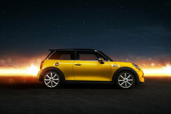 Yellow mini cooper s on a starry sky background