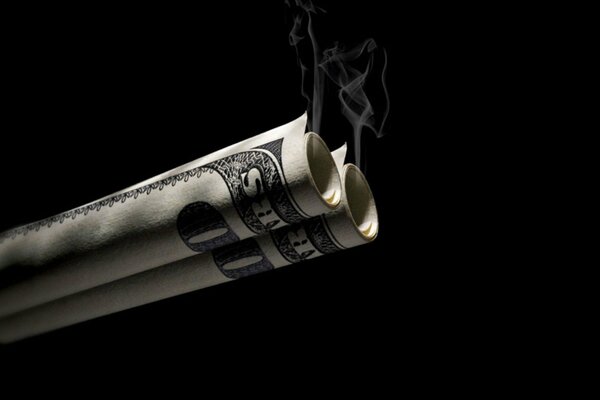 Rauch aus verdrehtem Geld auf schwarzem Hintergrund