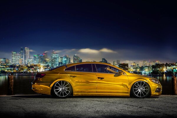 Golden supercar against the background of distant skyscrapers