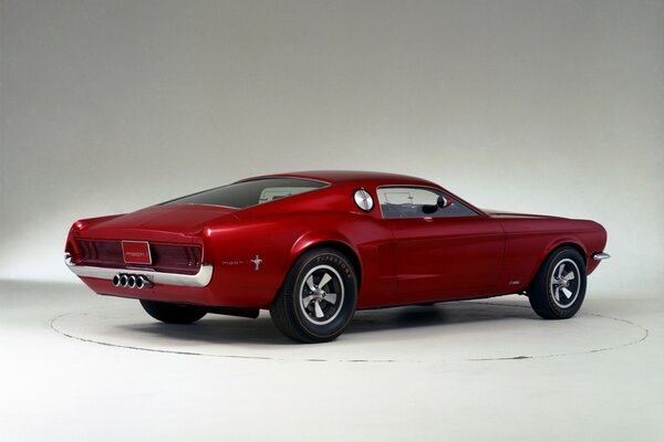 A red mustang on a white platform