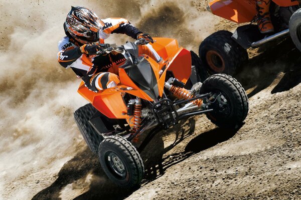 A man on an ATV rides on the sand