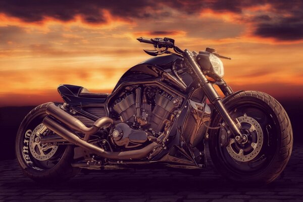 A beautiful motorcycle stands against the sunset