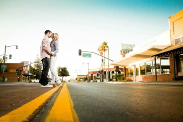 Two lovers on the road marking. gentle embrace of a man and a woman. shooting in love