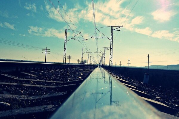 Reflection of the pillars in a shiny metal rail