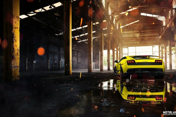 Yellow car in the hangar, reflected in the shiny floor