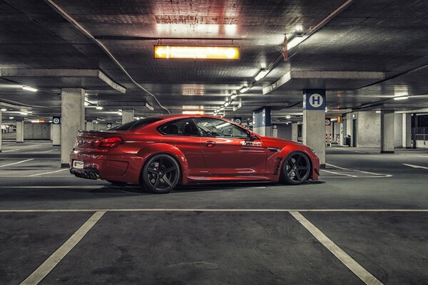 Red bmw m6 in the parking lot on the side