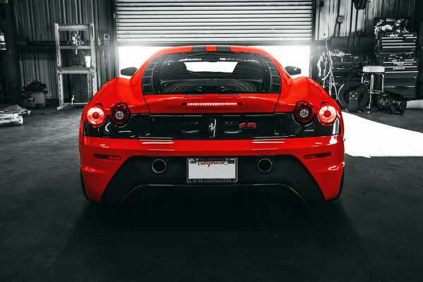 Italian red ferrari f430 sports car in the garage