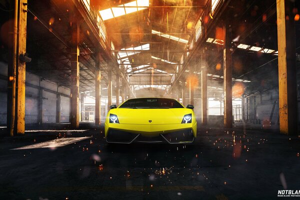 The yellow sports car is in the hangar