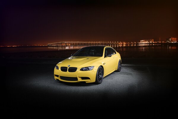 Yellow BMW on the background of the night city