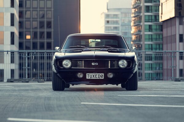 Urban landscape. Black chevrolet camaro