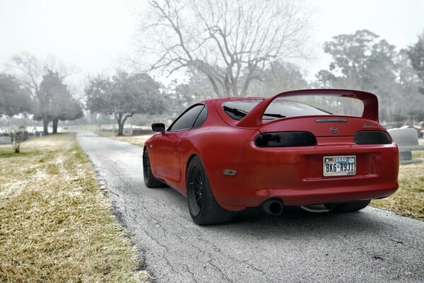 The red Toyota Supra stopped on an empty road