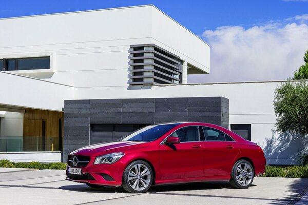 Red Mercedes-Benz on the background of the building