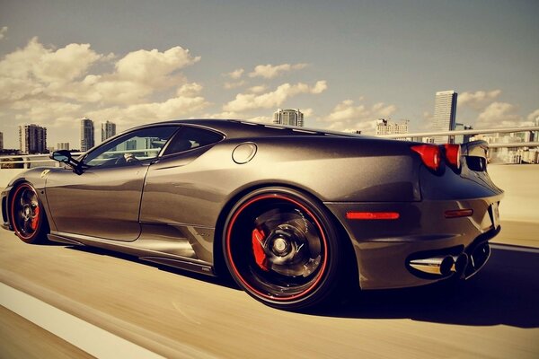 Sports car on the background of the sky and the city