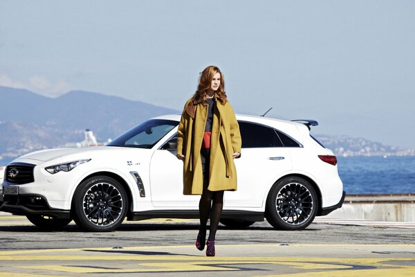 Model on the background of the sea and the car