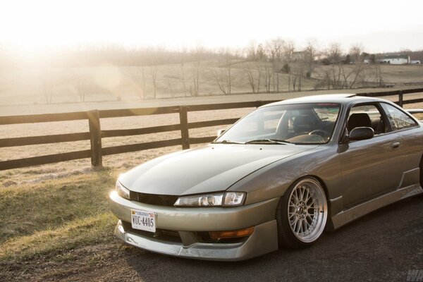 Silver Nissan on the background of intake and sunlight