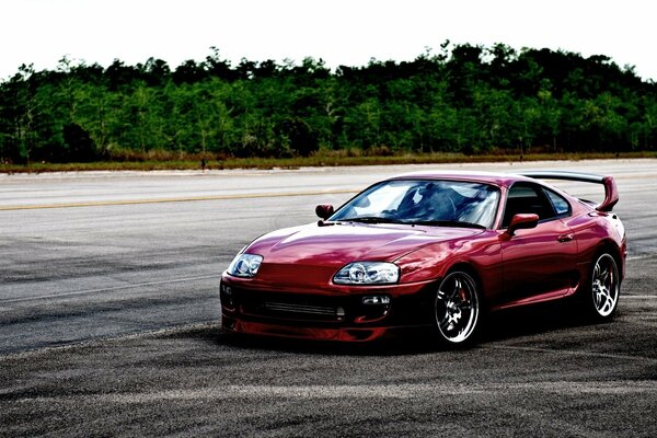 Red sports car near the forest