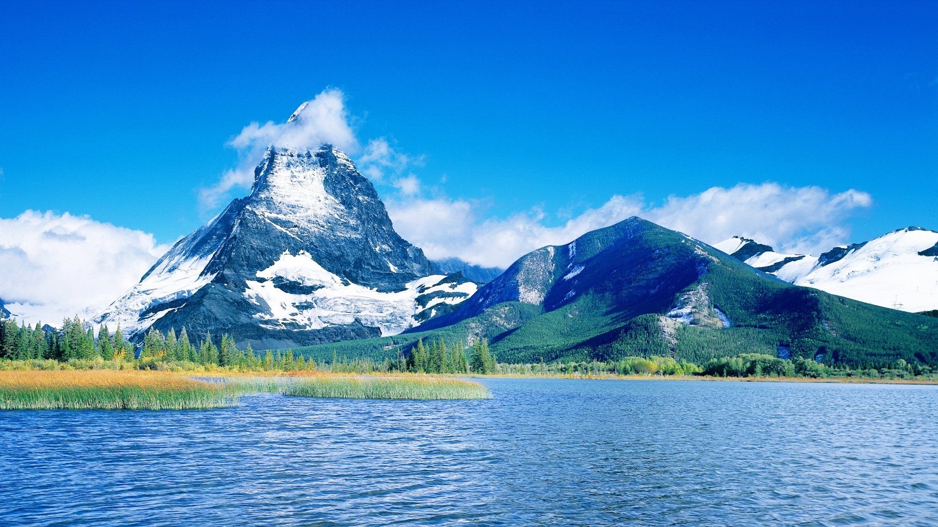 mountains snow on top blue water water the sky lake blue sky clouds forest