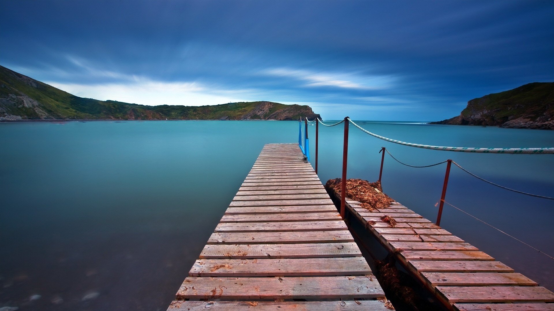 rope porucnika a wooden pier water spaces water the sky lake surface mountains pierce sunset blue sky turquoise landscape