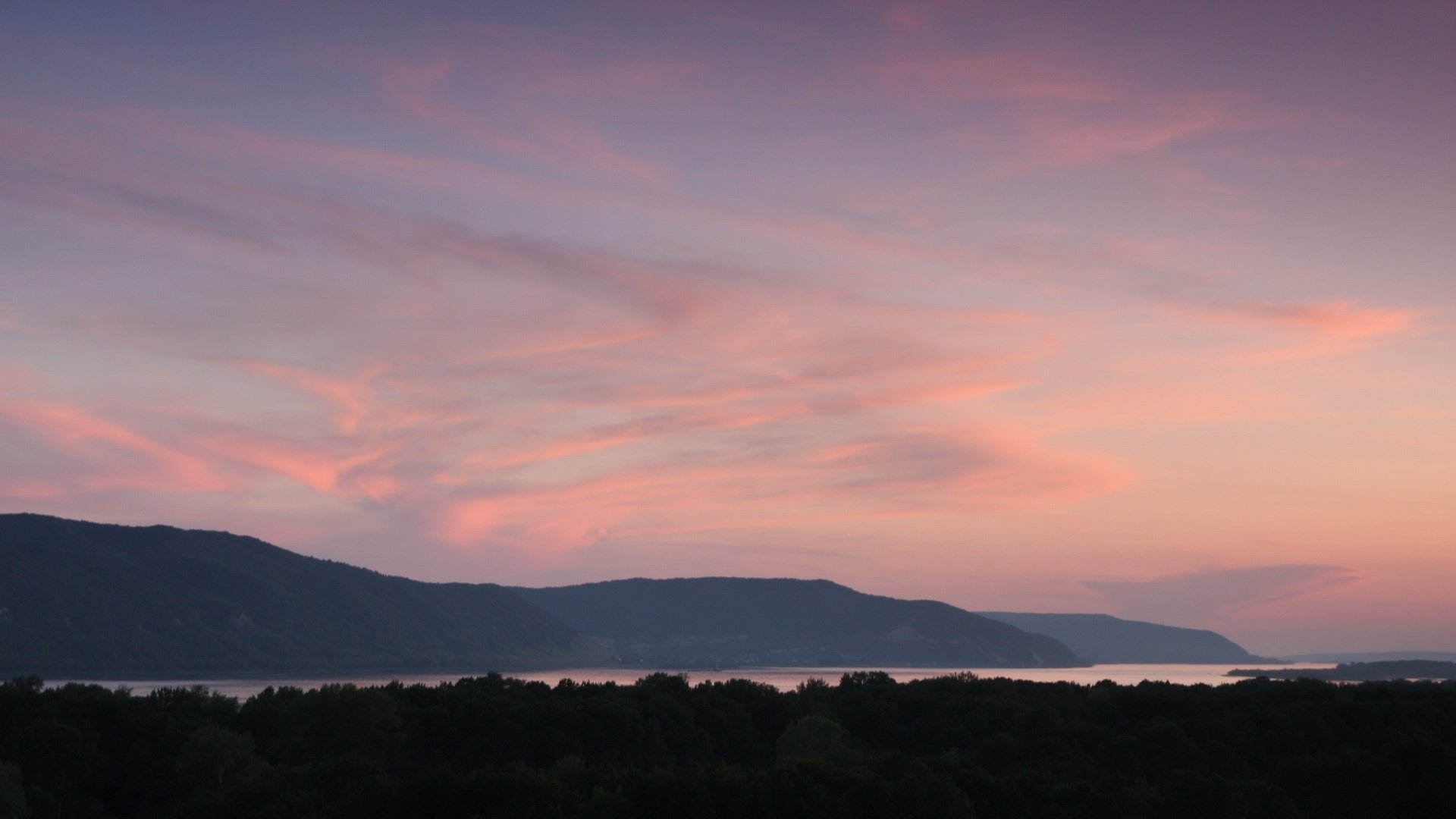 cotton clouds pinkish sky the sky mountains mounds sunset forest lake surface hills nature landscape