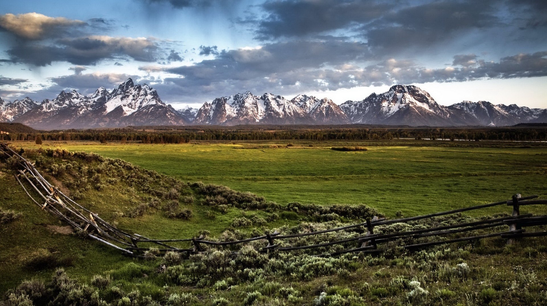 pastures a small fence mountains clouds fence nature landscape greens meadow