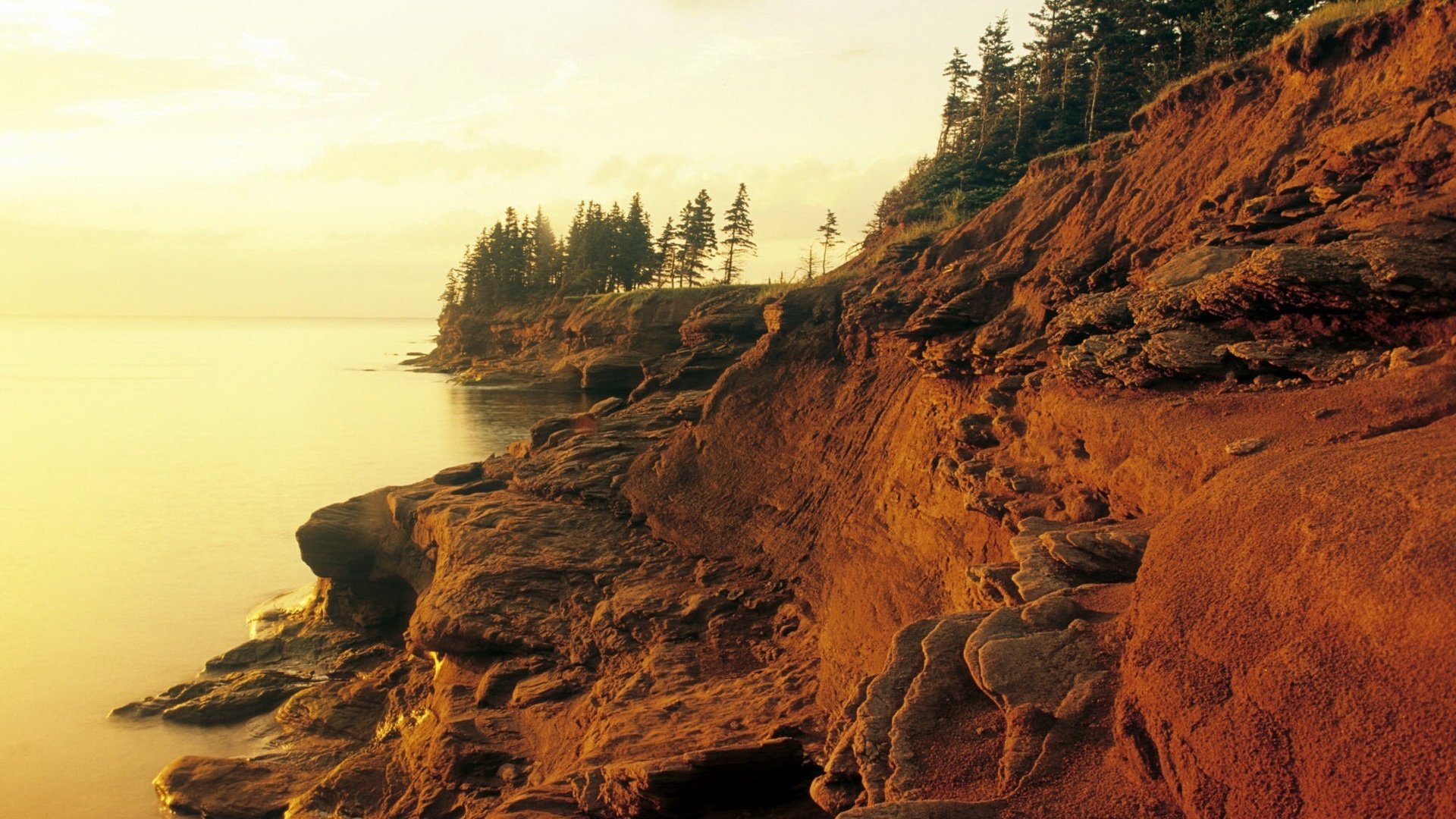 red rocks soil a joint in the water steep bank stones lake fog horizon open rocks landscape nature mountains tree trees surface water