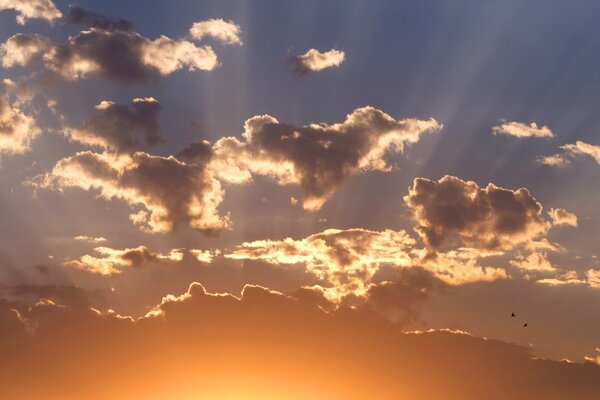 Sunlight breaks through the clouds at sunset