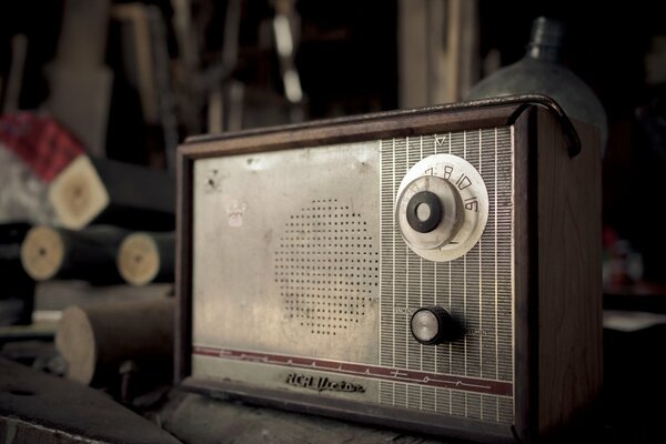 Old radio receiver on the background of tools and parts