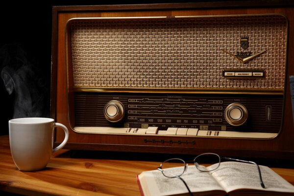 Glasses and knina on the background of an old radio