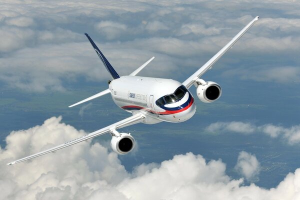 The superjet plane flies over the surface of the sky