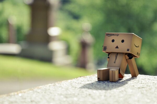 Cardboard man sitting on concrete