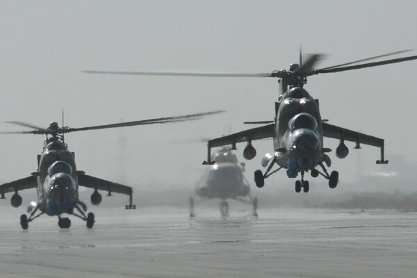 Photo with helicopters taking off from the airfield in the fog