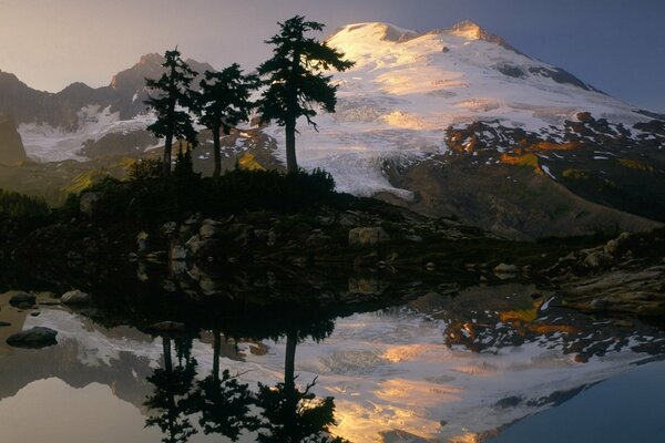 Lake reflecting Snow-capped Mountains