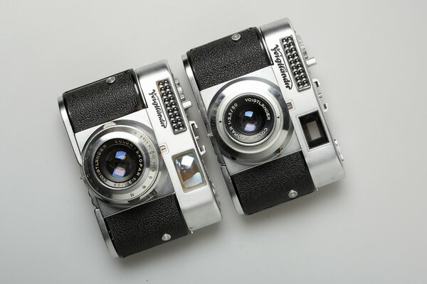 A pair of macro cameras on a solid gray background