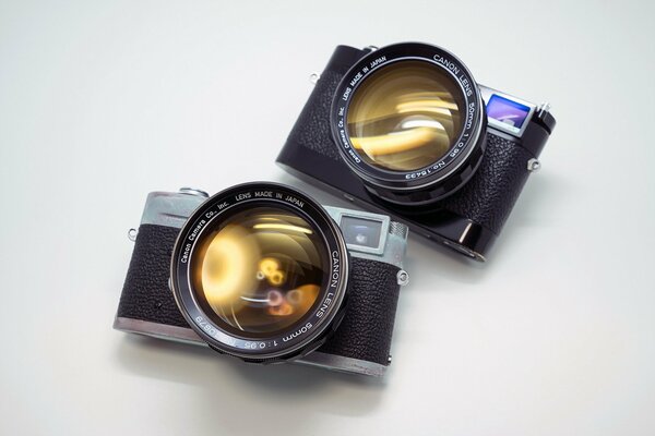 Cameras with large lenses on a white background