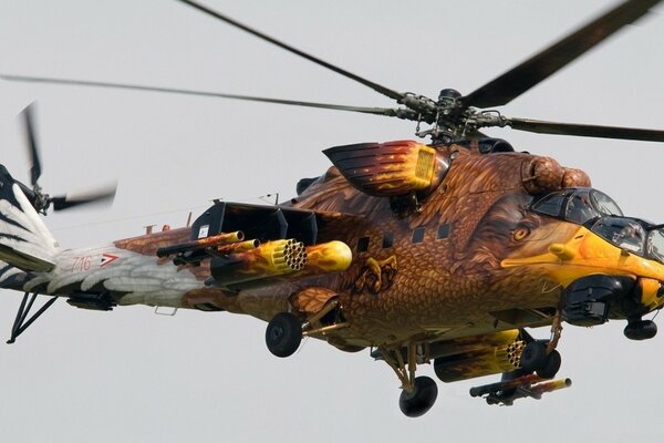 Helicopter in the form of an eagle on a gray sky background