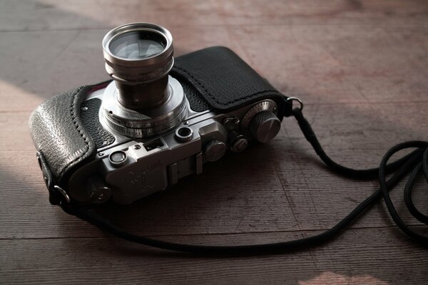 A camera in a leather case on a string