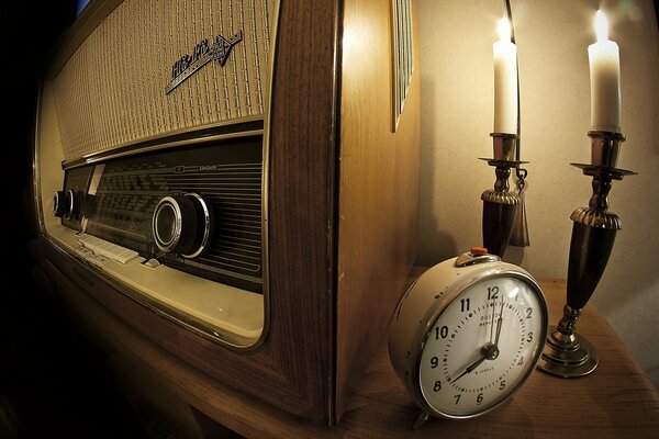 Radio, clock and lighted candles