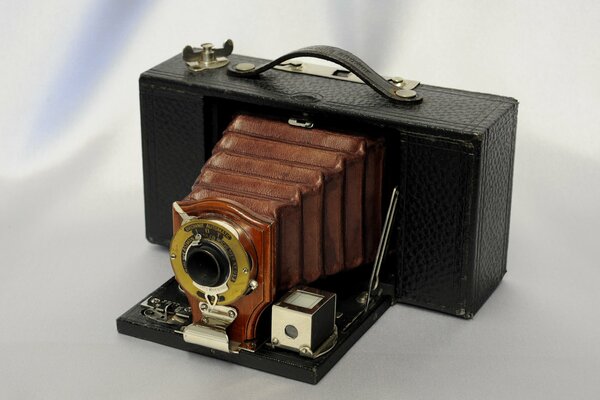 Vintage folding camera on a light background