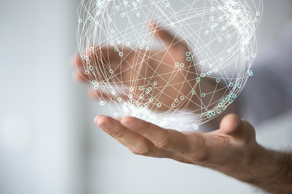 Projection of a weightless ball of technology in human hands