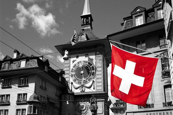 A black and white city with a white cross on a red background