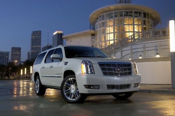 Cadillac blanco en las carreteras de la ciudad nocturna