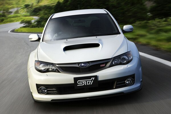 Subaru car is driving along the highway in the forest beautiful picture