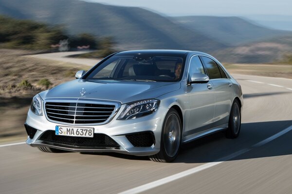 Mercedes is speeding down the road at high speed