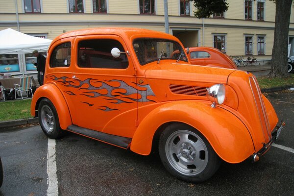 Bright orange vintage car in the parking lot