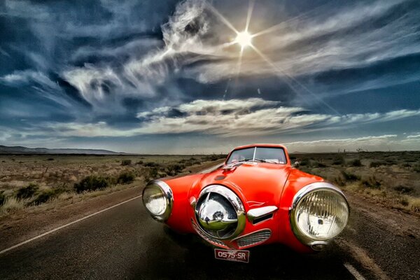 An unusual red car with large headlights