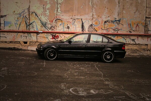 A black car at the old wall