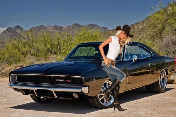 Black Chevrolet with a car next to the background of the mountains