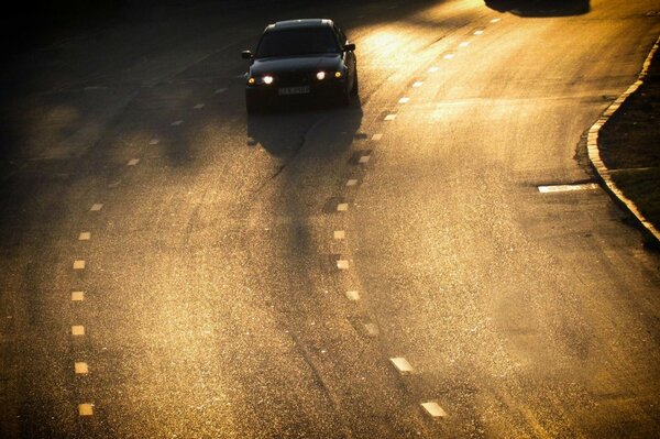 Bmw rushes along the evening highway