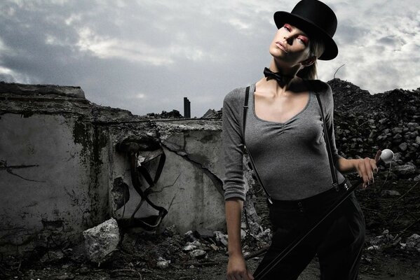 A girl in a hat on the background of ruins