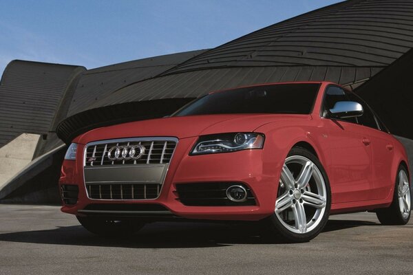 Red audi s4 on the background of the building